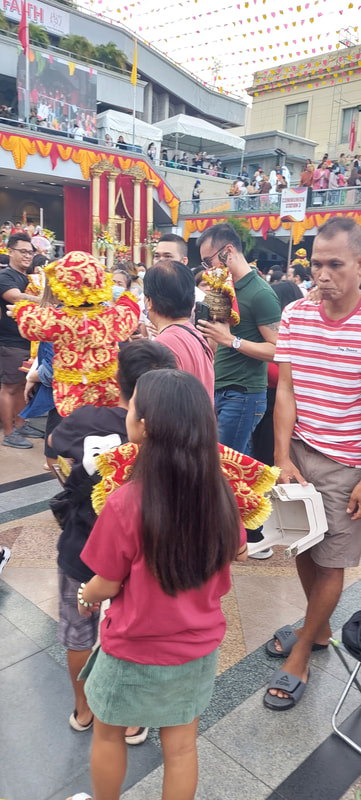 Devotees carrying statues of the Holy Child Jesus or the Santo Niño at the Basilica Minore del Santo Niño de Cebu right after Walk with Jesus.