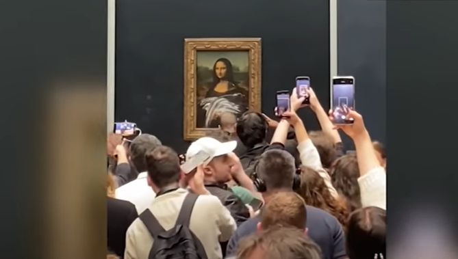 Man in disguise throws a cake at the 'Mona Lisa'.